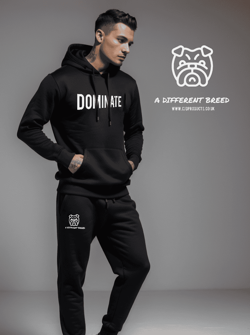 Man wearing a black hoodie with bold Dominate in white print and black jogging bottoms with a cuff bottom with the a different breed and bulldog head logo also printed in white