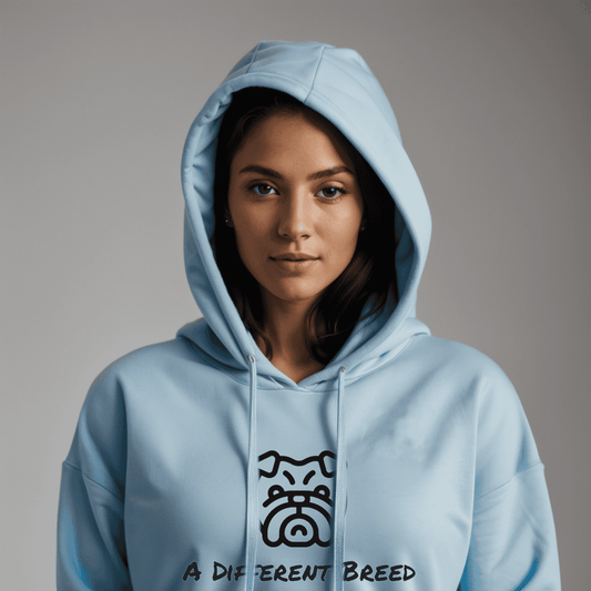 Woman wearing light blue hoodie with  a print which reads a different breed across the chest