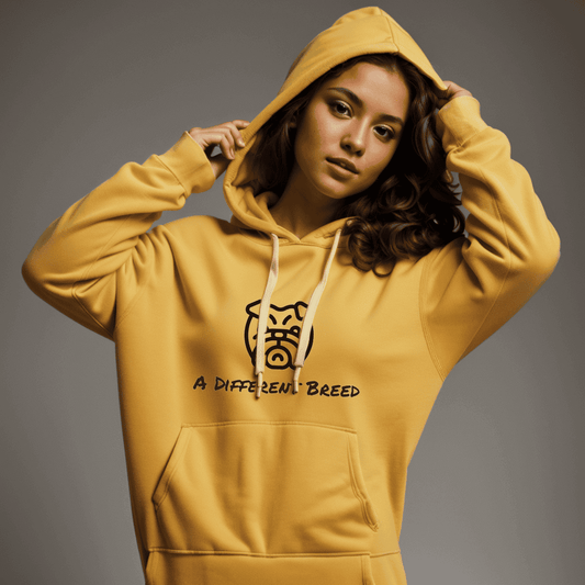 Woman wearing yellow hoodie with  a print which reads a different breed across the chest