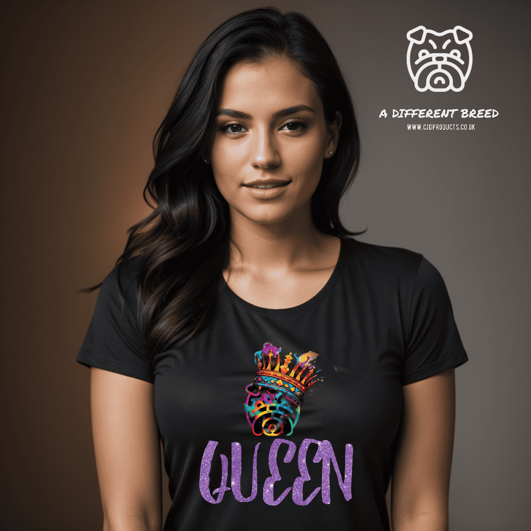A lady wearing a black t-shirt with the word QUEEN written in a purple text with some sparkles and the a different breed logo in multi colour and wearing a crown place on top of the word queen