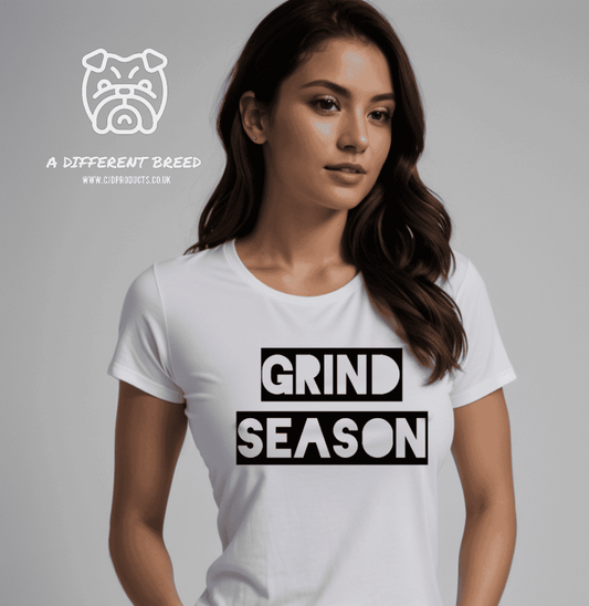 a woman wearing a white shirt that says grind season