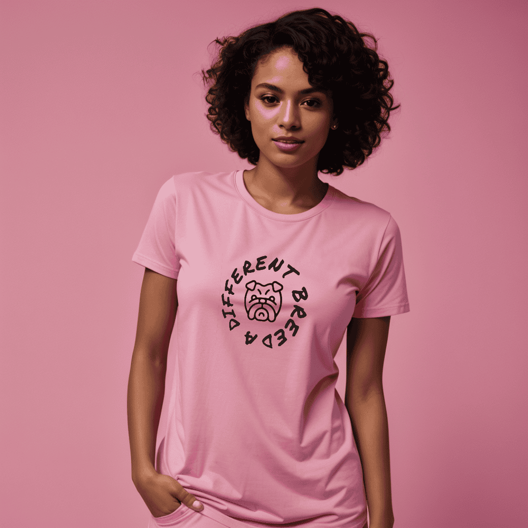 Woman wearing pink t-shirt with  a print which reads a different breed across the chest