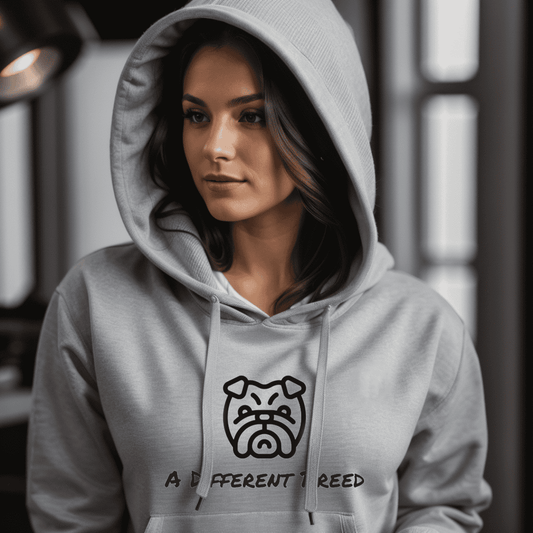Woman wearing grey hoodie with  a print which reads a different breed across the chest