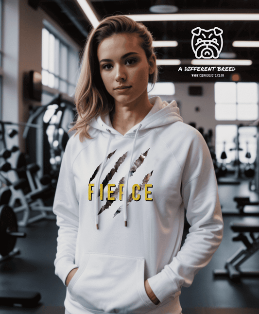 a woman in a white hoodie stands in a gym