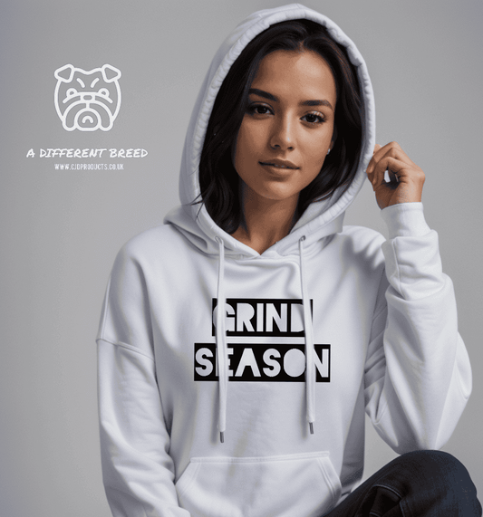 a woman wearing a white hoodie with the words grind season printed on it